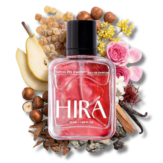 Perfume bottle labeled 'Hira' surrounded by flowers, fruits, and herbs on a white background