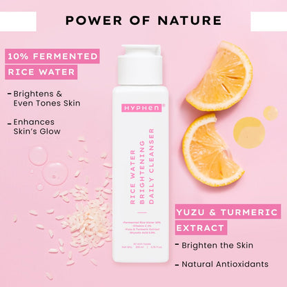 Hyphen rice water cleanser with yuzu and turmeric extract on a pink background