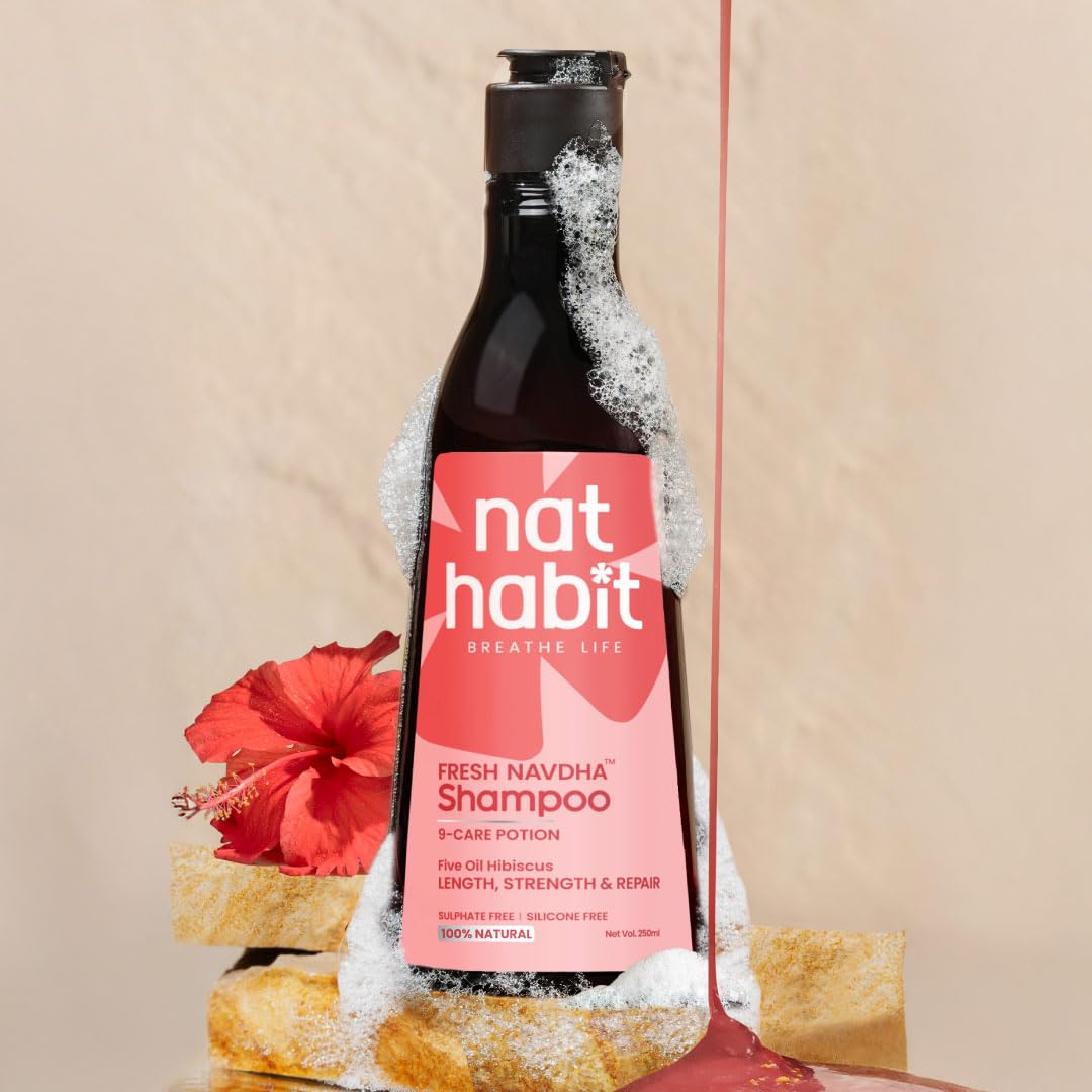 nat habit shampoo bottle with pink label on a beige background
