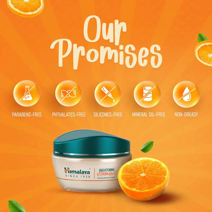 Himalaya Brightening Vitamin C Cream with orange slices on an orange background