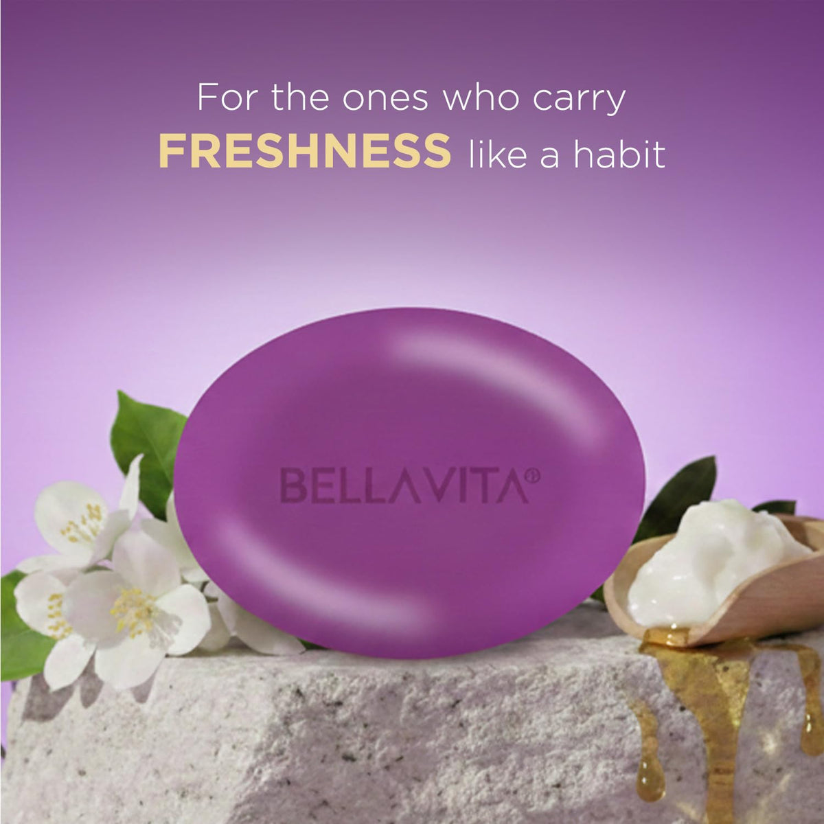 Purple bar of Bellavita soap with flowers and a wooden dish on a purple background