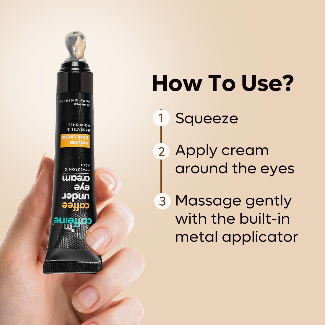 Hand holding a tube of eye cream with usage instructions on a beige background