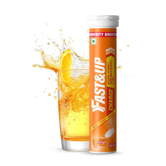 FAST&UP supplement tube with an orange slice and juice splash on a white background