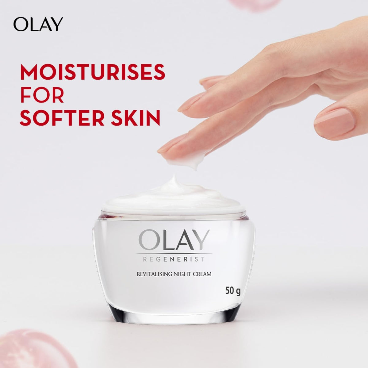 Olay moisturizer jar with hand applying cream on a light background
