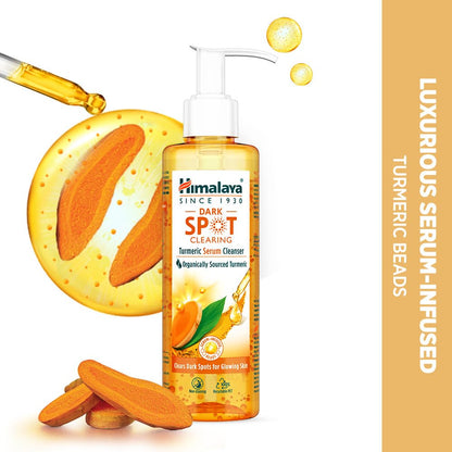 Himalaya Dark Spot Clearing Turmeric Serum Infused bottle with turmeric roots and serum beads on a white background