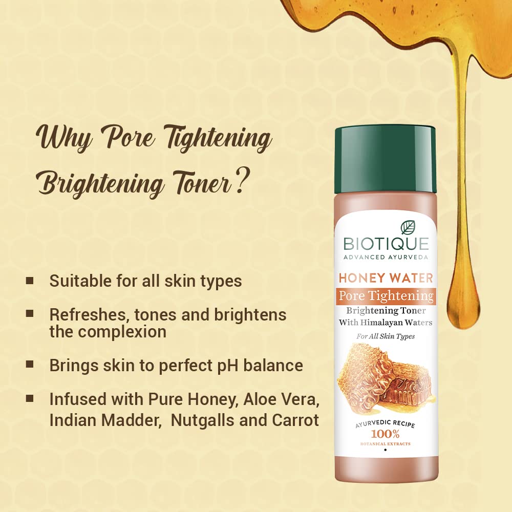 Biotique Honey Water Pore Tightening Toner bottle with honey drizzle on a beige background