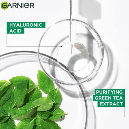 Garnier skincare product with hyaluronic acid and purifying green tea extract, featuring a magnifying glass and green leaves.