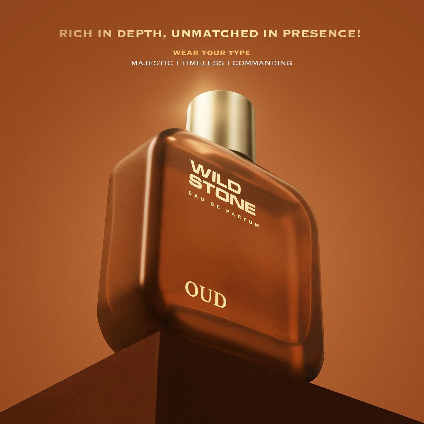 Brown Wild Stone Oud perfume bottle on a brown background with text.