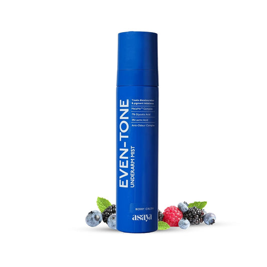 Blue skincare product bottle with berries on a white background