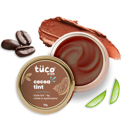 Tüsco Kids cocoa tint with coffee beans and aloe vera leaves on a white background