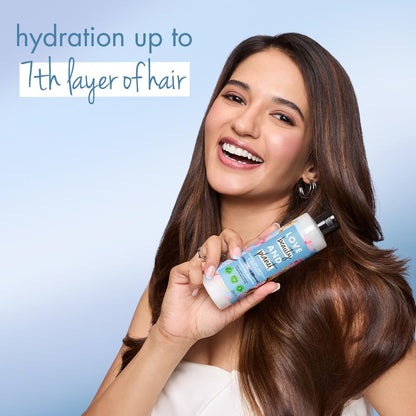 Woman holding a bottle of hair care product with text about hair hydration on a light blue background