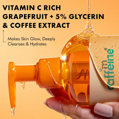 Hand holding a skincare product with text about vitamin C, grapefruit, glycerin, and coffee extract on an orange background.