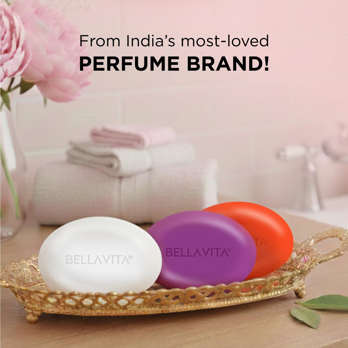 Three BellaVita soaps on a decorative tray with a pink background and text about being from India's most-loved perfume brand.