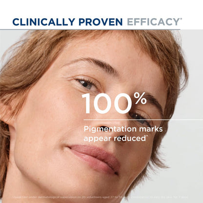 Close-up of a person's face with text claiming 100% reduction in pigmentation marks.