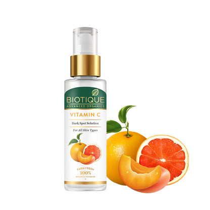 Biotique Vitamin C dark spot solution bottle with orange and grapefruit illustrations on a white background