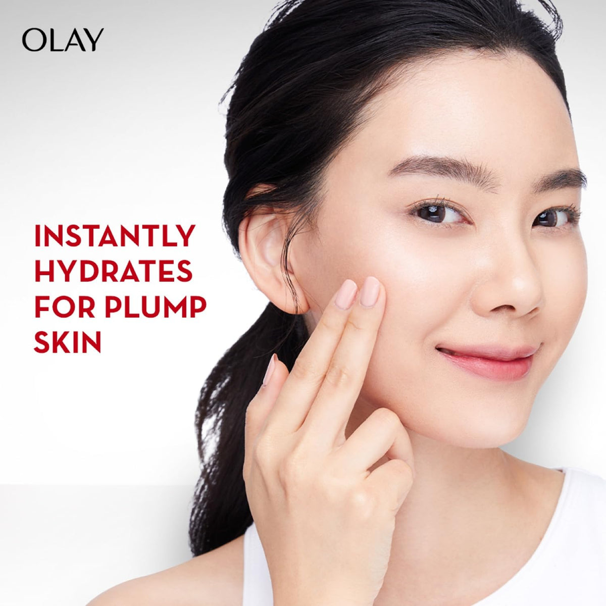 Woman touching her face with Olay skincare product, featuring text 'Instantly hydrates for plump skin'.