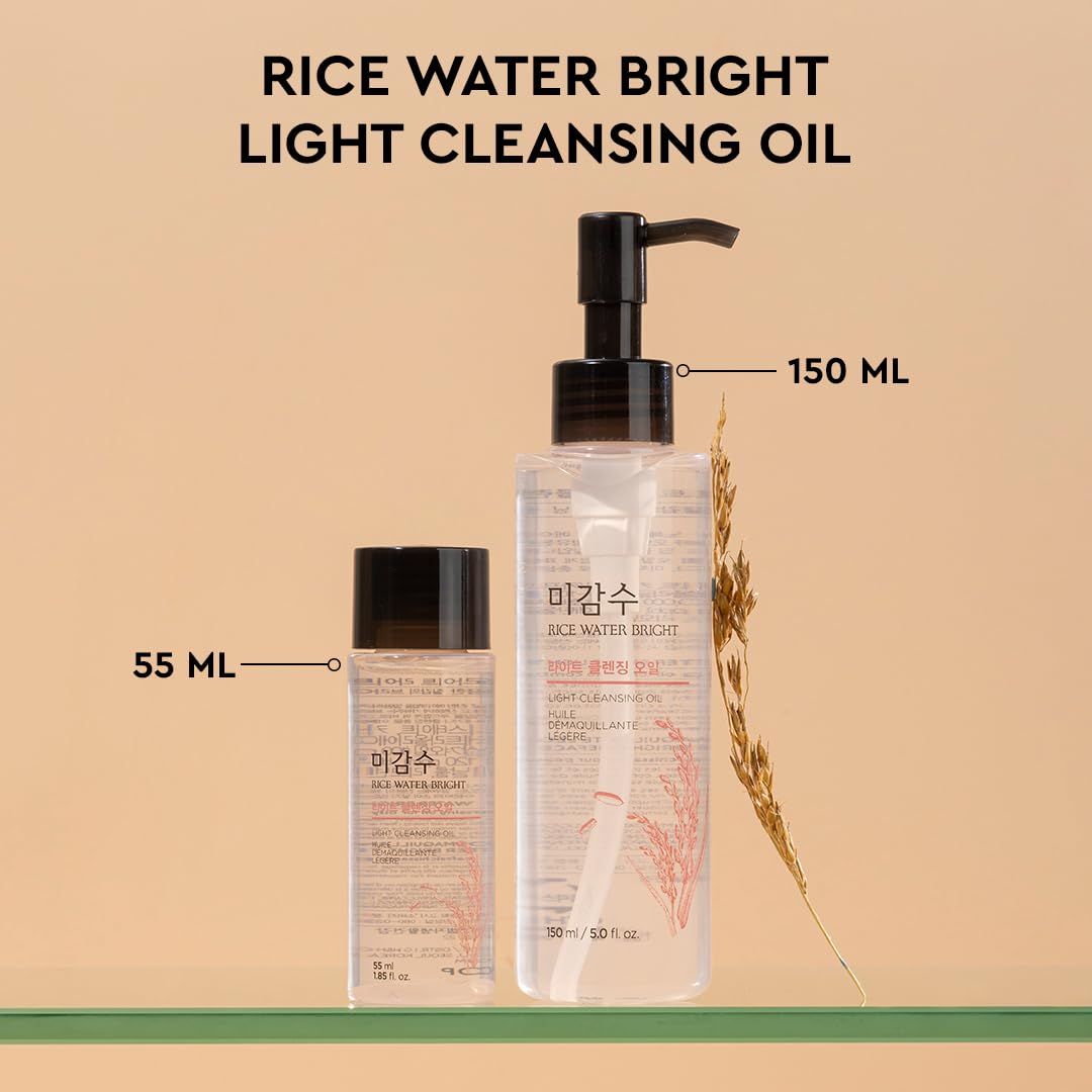 Two bottles of rice water bright light cleansing oil with labels indicating volume on a beige background.