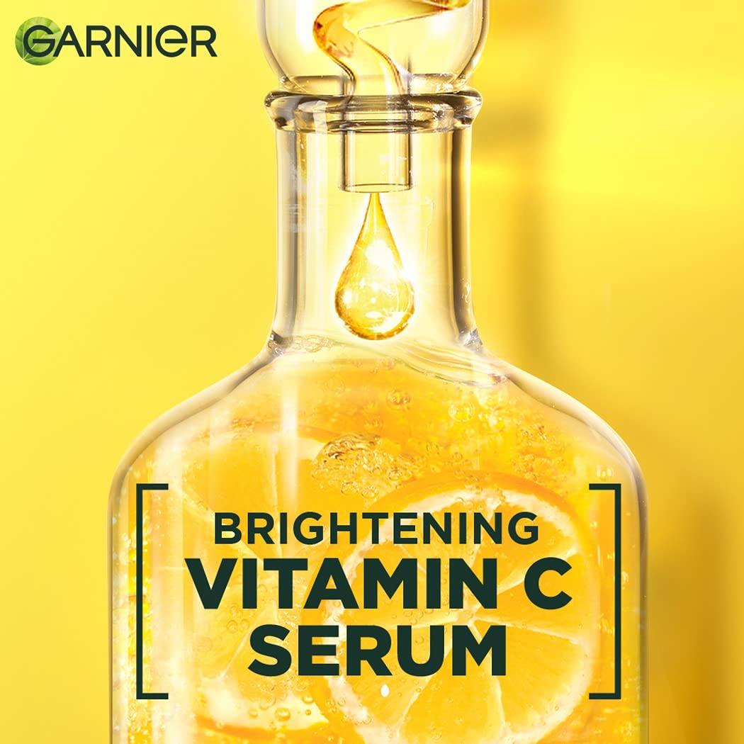 Garnier brightening vitamin C serum bottle with a yellow background