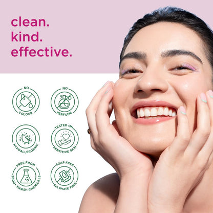 Woman with a radiant smile holding her face, with 'clean. kind. effective.' text and icons on a pink background.