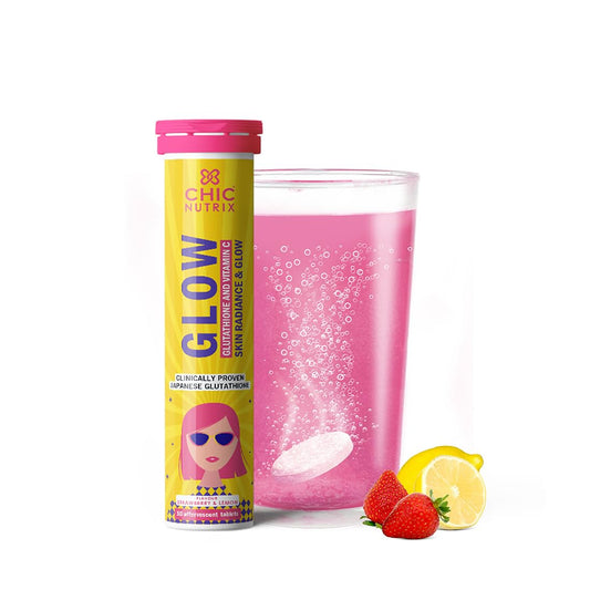 Chic Nutrix Glow supplement tube with a glass of pink drink, strawberry, and lemon on a white background