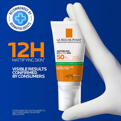 La Roche-Posay sunscreen tube held by a gloved hand on a blue background