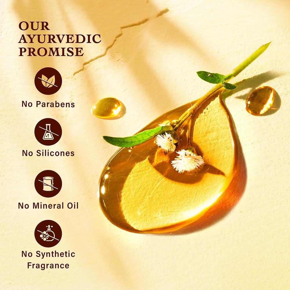 Ayurvedic product with oil droplets and a plant stem on a beige background, featuring a promise of no parabens, silicones, mineral oil, or synthetic fragrance.