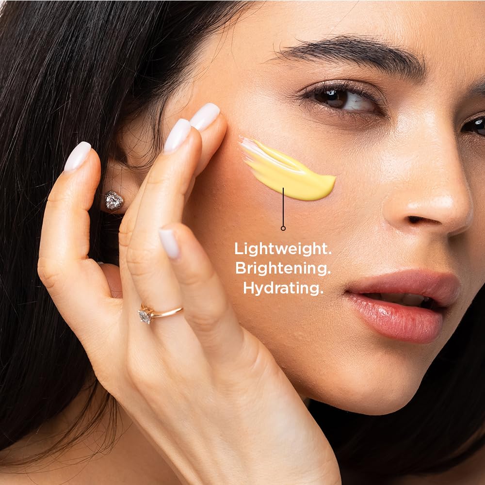 Woman applying a yellow skincare product to her face with text 'Lightweight. Brightening. Hydrating.'
