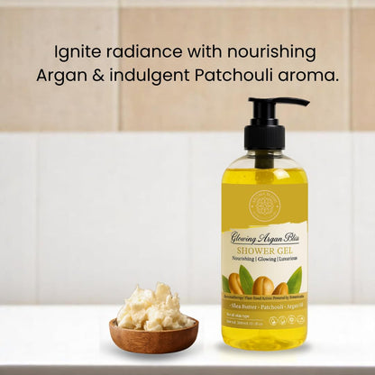 Shower gel bottle with argan and patchouli ingredients on a bathroom counter.