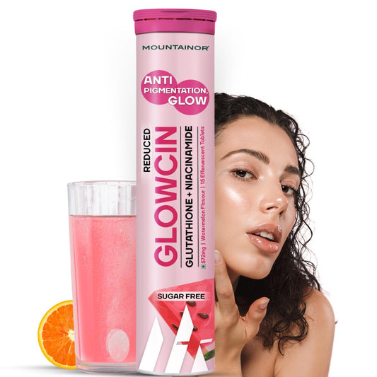 Mountainor Glowcin supplement tube with a glass of pink drink and an orange slice on a white background.