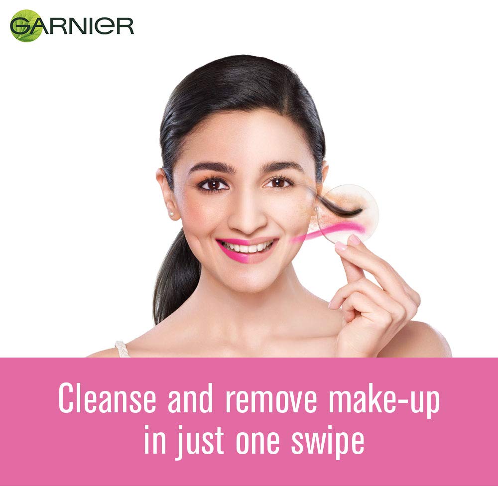 Woman using a makeup removal product with Garnier branding and text on a white background