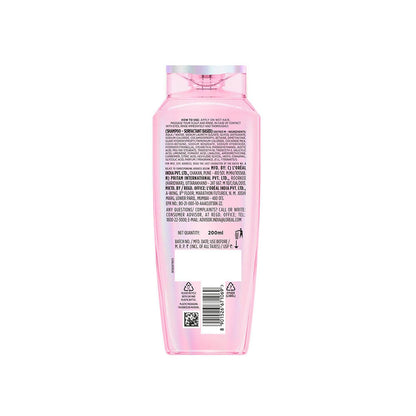 Back view of a pink shampoo bottle with text and a barcode on a white background