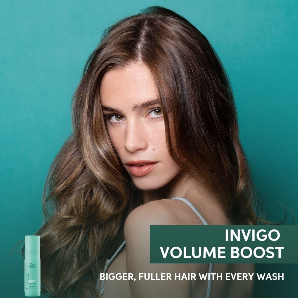 Woman with voluminous hair against a teal background with Invigo Volume Boost product.