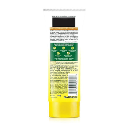 Back view of a yellow skincare product container with text and branding on a white background
