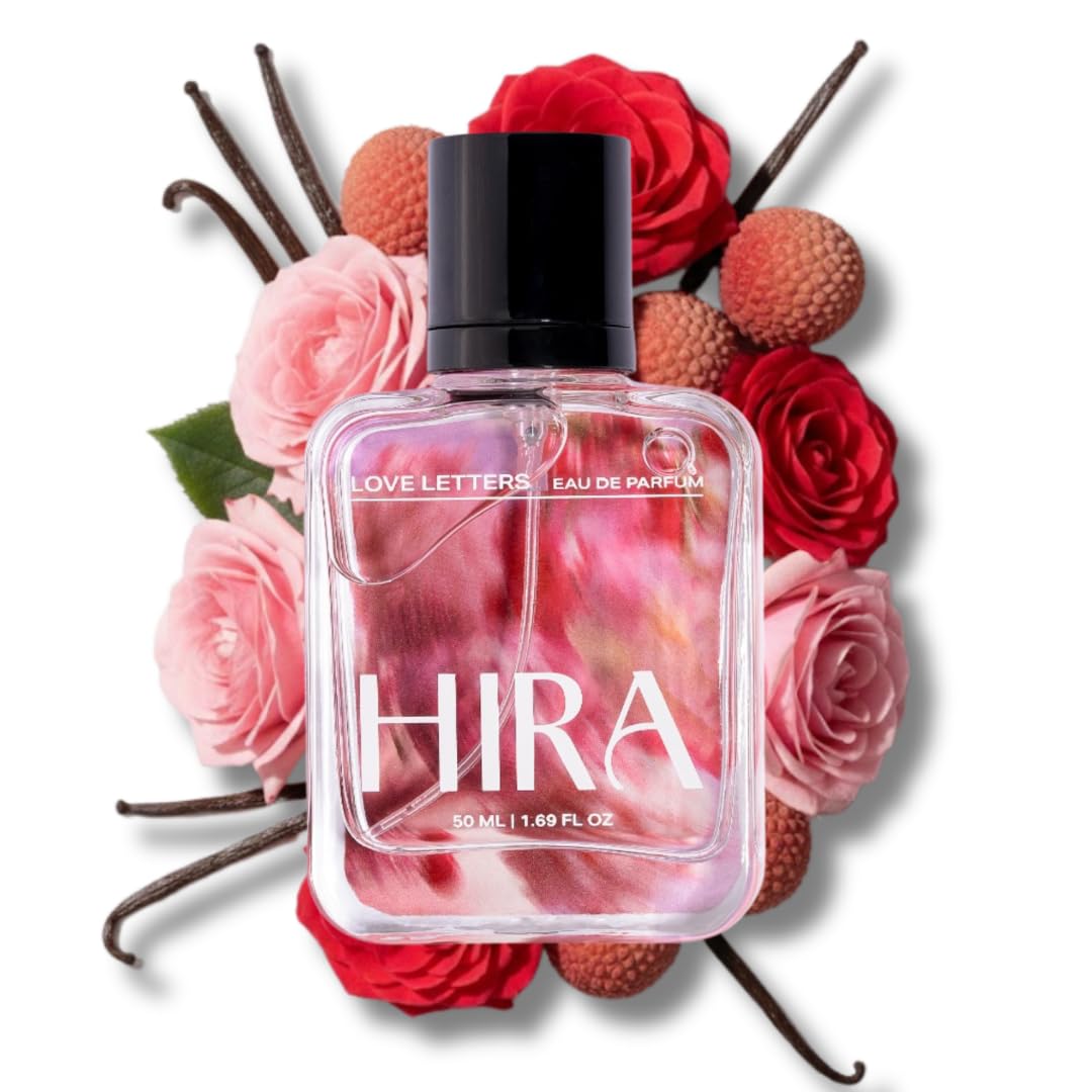 Perfume bottle labeled 'HIRA' surrounded by flowers and vanilla beans on a white background