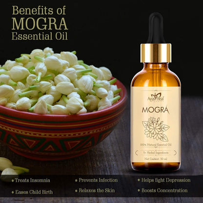 Bottle of Avus Heal Mogra essential oil with a bowl of mogra flowers on a dark background