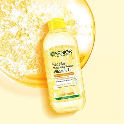 Garnier Micellar Cleansing Water Vitamin C bottle with bubbles on a yellow background