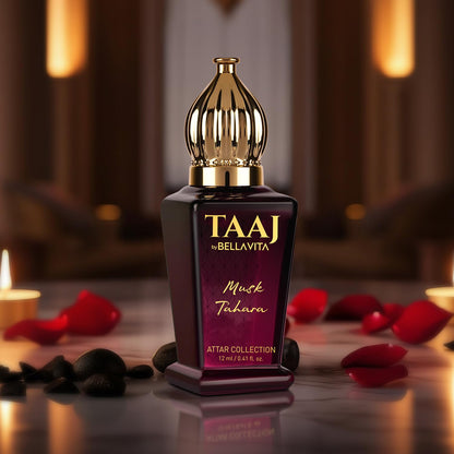 TAAJ by Bellavita Musk Tahara Attar Collection bottle with candles and rose petals in the background