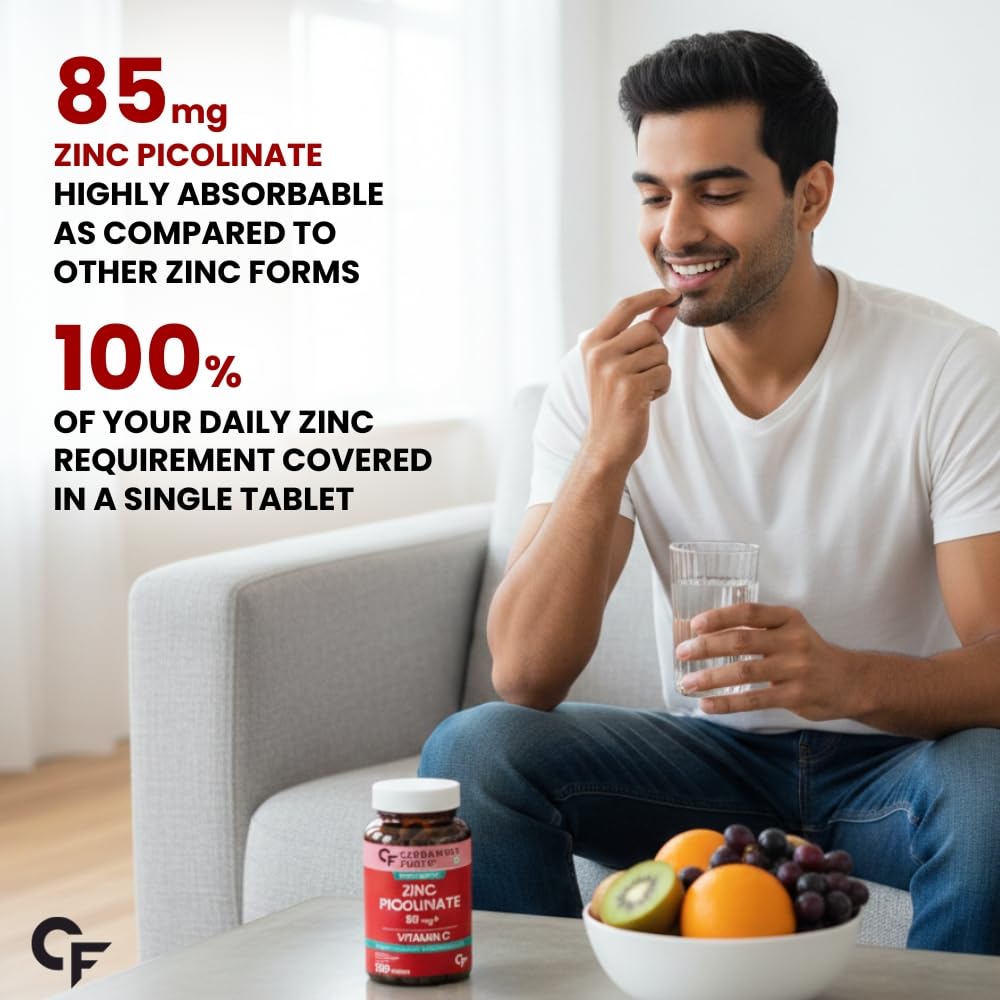 Man holding a glass of water with a bowl of fruits and a supplement bottle on a table, with text about zinc picolinate supplement.