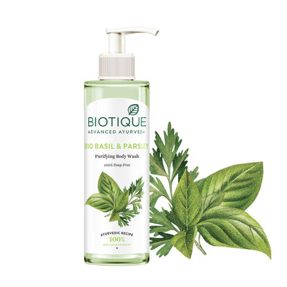 Biotique basil and parsley body wash bottle with leaves on a white background