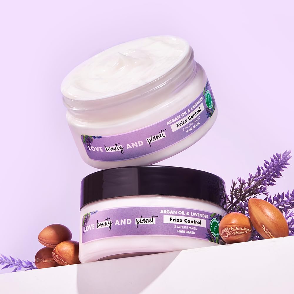 Two jars of 'Love Beauty and Planet' hair mask on a light purple background with lavender and nuts.