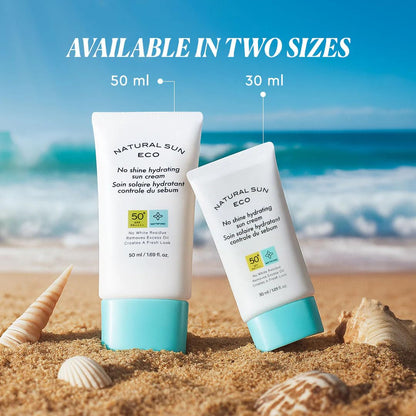 Two sunscreen bottles on sand with ocean view, text indicating sizes 50 ml and 30 ml.