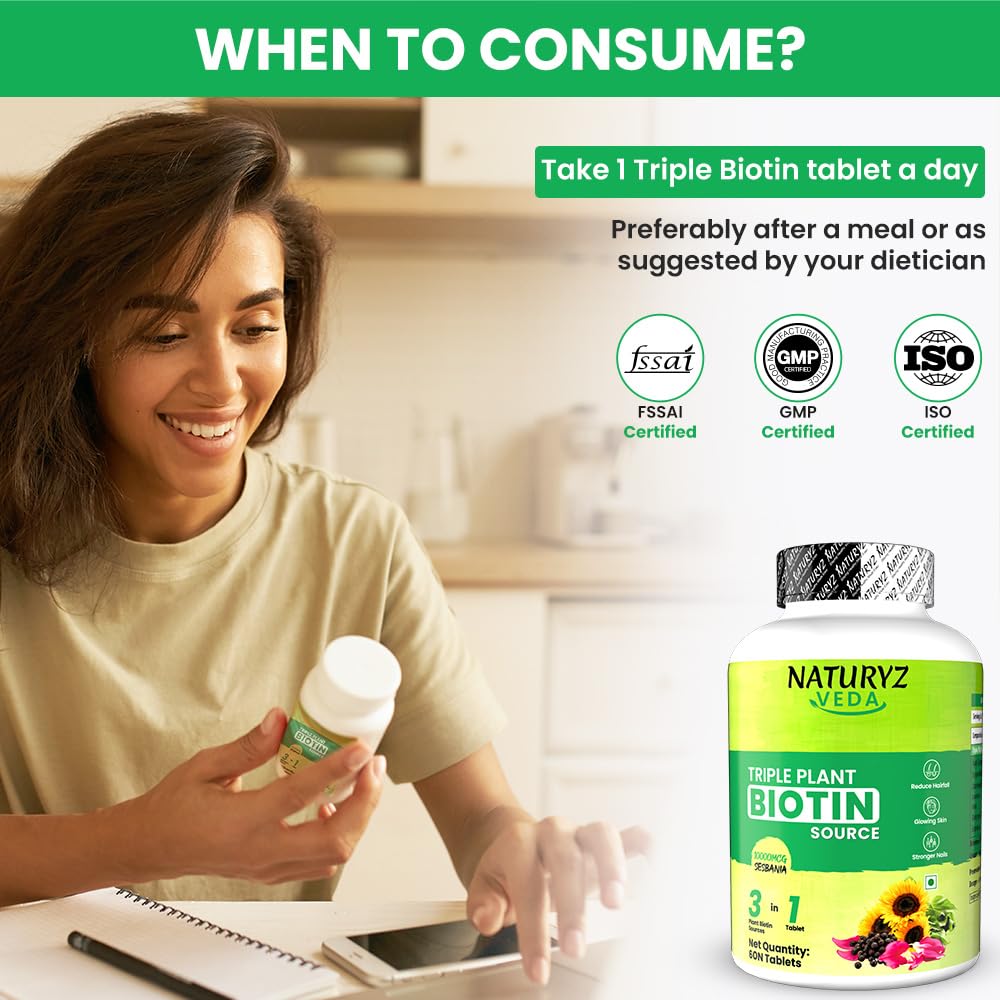 Woman holding a bottle of Naturyz Veda Triple Plant Biotin tablets with certification logos on a blurred background.