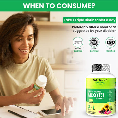 Woman holding a bottle of Naturyz Veda Triple Plant Biotin tablets with certification logos on a blurred background.