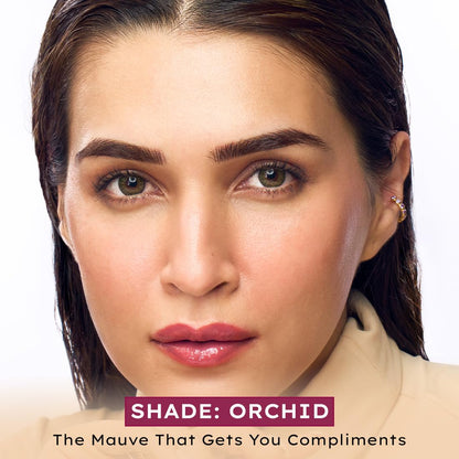 Close-up of a woman's face with 'Shade: Orchid' text on a white background