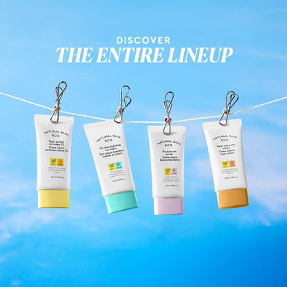 Four sunscreen cream tubes hanging on a line with a blue sky background