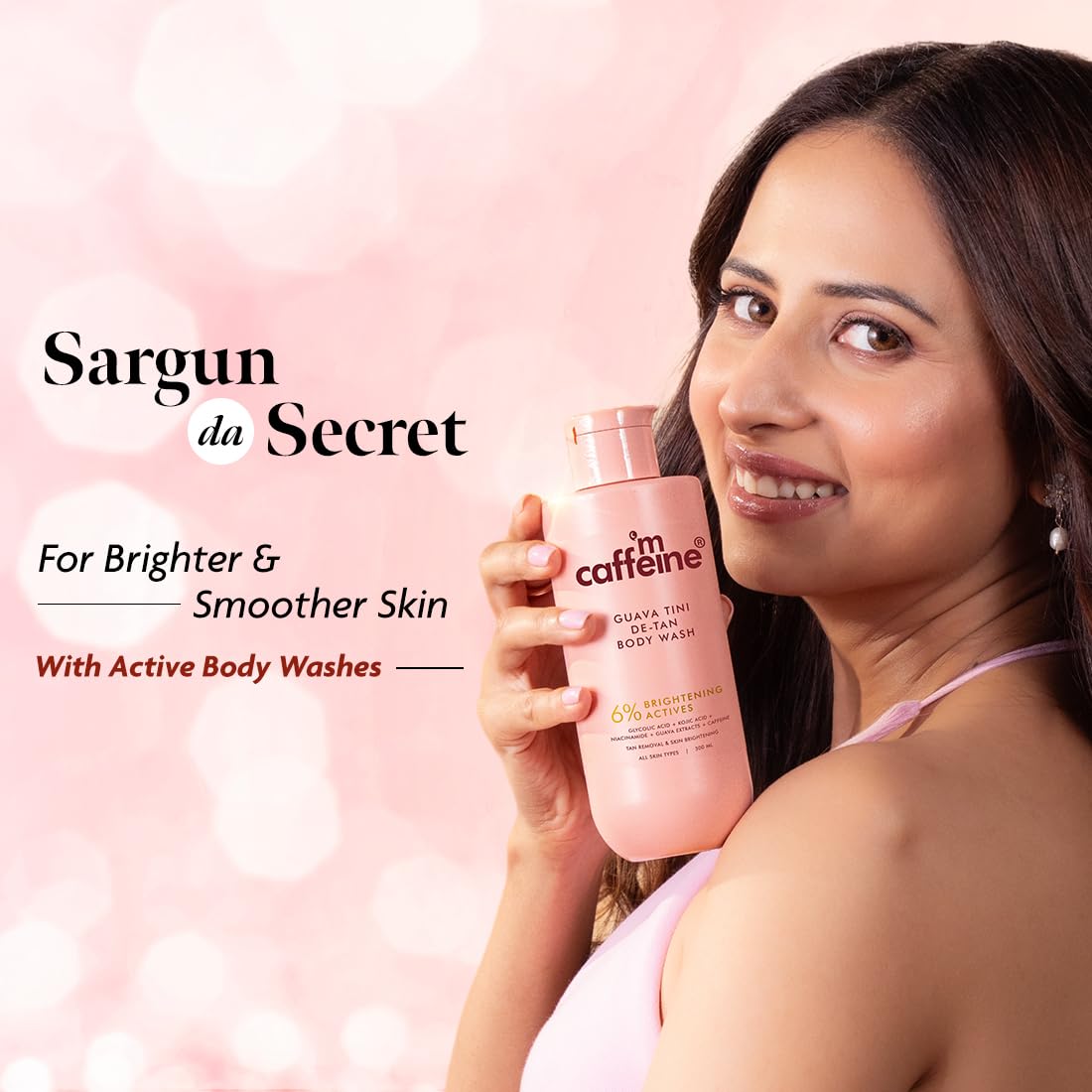 Woman holding a pink body wash bottle with 'Sargun da Secret' branding on a pink background.
