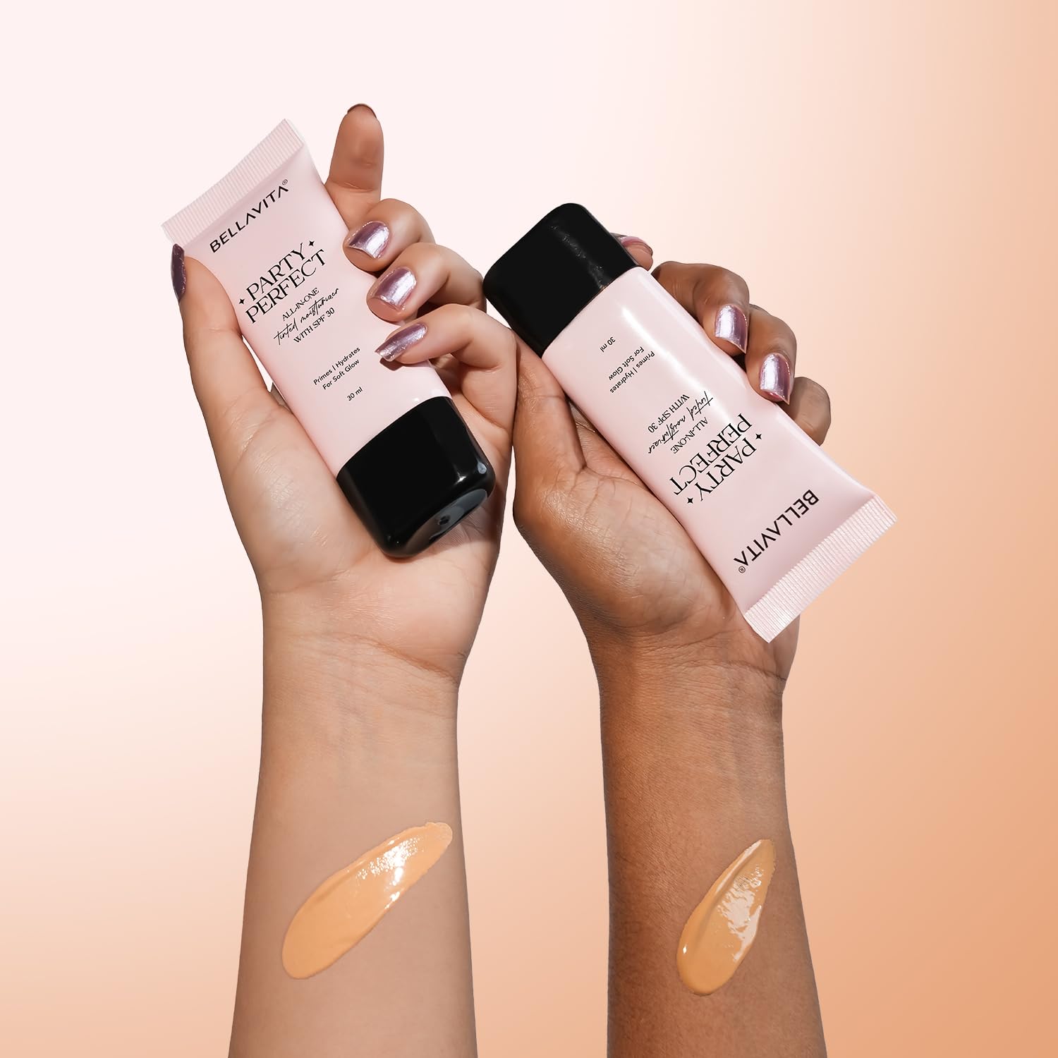 Two hands holding Bellavita foundation bottles with swatches on a beige background