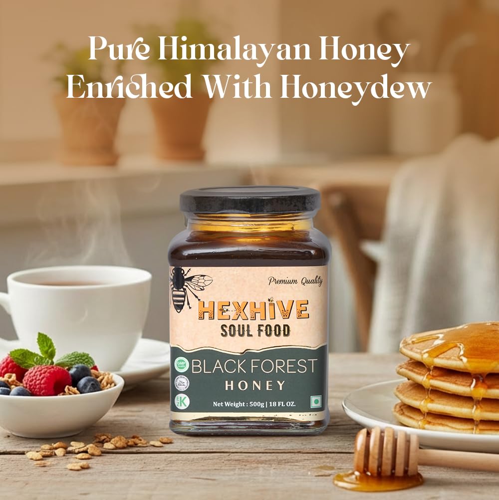 Jar of Hexhive Black Forest Honey on a table with a cup of coffee, fruits, and pancakes.