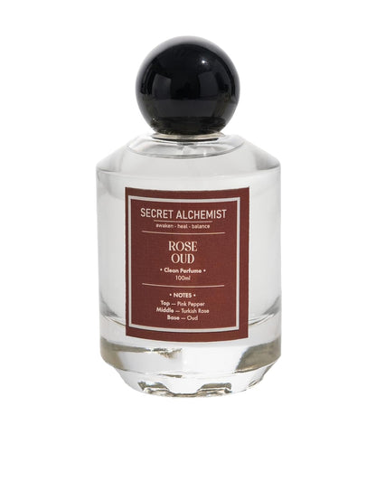 Perfume bottle labeled 'Rose Oud' by Secret Alchemist on a white background