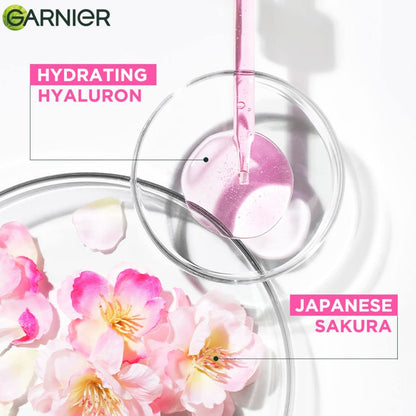 Garnier skincare product with pink floral elements and 'Hydrating Hyaluron Japanese Sakura' text.